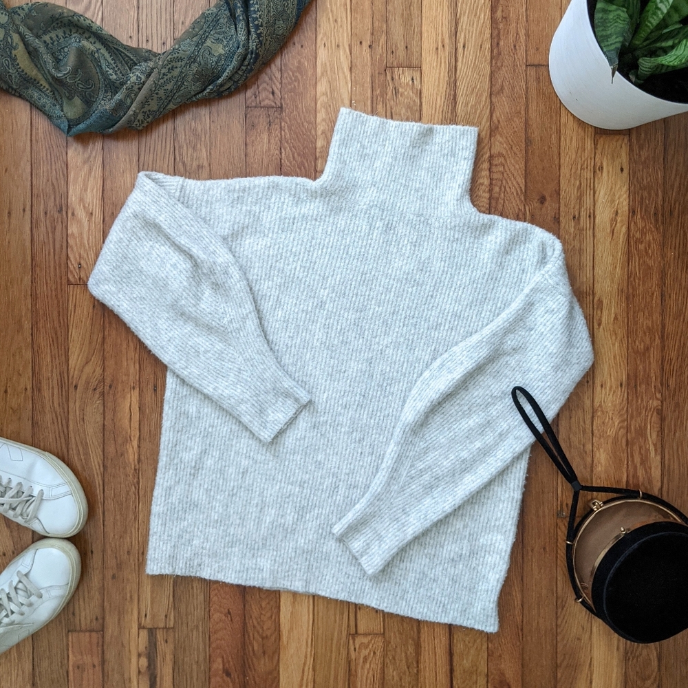 Cozy light gray turtleneck sweater with unique sleeves